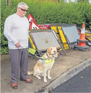  ?? Picture: Steven Brown. ?? Ian Muir and his guide dog Tel have received an apology after having to walk across hot tar.