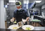  ??  ?? Steve Kemper, part owner and executive chef at the Go Fish! Seafood Restaurant in Sinking Spring, prepares food in the kitchen on Thursday afternoon.