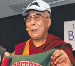  ??  ?? The Dalai Lama got a Rabbitohs cap and jersey.