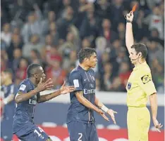  ??  ?? IT’S RED: Referee Alexandre Castro (right) awards a red card to Paris Saint-Germain’s Thiago Emillano Da Silva as Blaise Matuidi (centre) protests during their French Ligue 1 match against Valencienn­es at the Parc des Princes stadium in Paris. —...