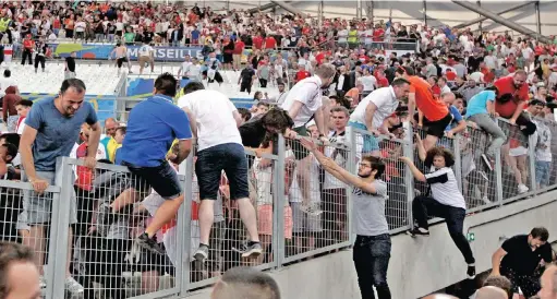  ?? PICTURE: AP ?? RUSH FOR SAFETY: Spectators run on the stands as clashes break out after the Euro 2016 match between England and Russia, at the Velodrome in Marseille on Saturday.