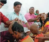  ??  ?? Indian Hindu devotee Punitha (right), 32, gets her head shaved at the Thiruthani Murugan Temple.