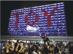  ?? (Reuters) ?? PEOPLE CELEBRATE the winning of the Eurovision Song Contest in 2018 by Netta Barzilai with her song ‘Toy,’ at Rabin Square in Tel Aviv in May.