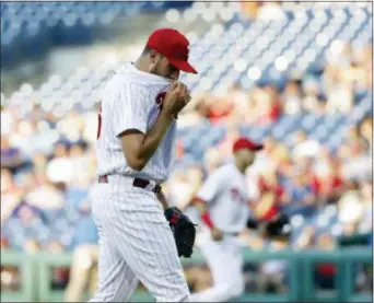 ?? MATT SLOCUM — THE ASSOCIATED PRESS ?? Phillies starting pitcher Zach Eflin wipes his face after the first inning against Jays. It didn’t get any easier for Eflin, who was knocked out in the fifth. the Blue