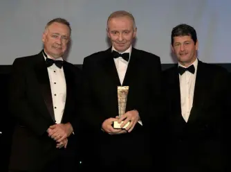  ??  ?? Pictured receiving the Contractor of the Year Award from Sean Twomey, partner at Eugene F Collins, right, were Paraic Keogh, left, and Eamon Booth, centre, of John Paul Constructi­on