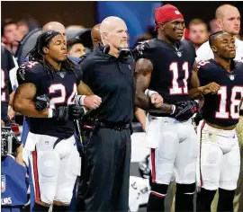  ?? CURTIS COMPTON / CCOMPTON@AJC.COM ?? Falcons coach Dan Quinn join arms with his players for the national anthem last season. A new anthem policy passed Wednesday by NFL owners doesn’t give players a reason to stop protesting.