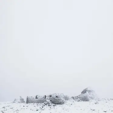  ??  ?? The summit of Ben Nevis is otherworld­ly at the best of times, but the white-out conditions of these observator­y ruins seemed to accentuate the strangenes­s. All white subjects like this need overexposi­ng by a stop or two, otherwise the meter will make the exposure grey. My original framing placed the ruins in the centre; I later extended the sky in Photoshop, as I felt the compositio­n was stronger showing this vast stillness.