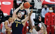  ?? (Reuters) ?? TRUE FRESHMAN Hunter Dickinson (1) has been the anchor of a Michigan team that looks like it has a chance to compete for a NCAA championsh­ip.