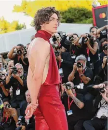  ?? Elisabetta A. Villa / Getty Images ?? Timothée Chalamet wore a halter top pantsuit and matching skinny tie at the Venice Film Festival.