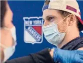  ?? NICK HOMLER/RANGERS VIA AP ?? The Rangers canceled practice Wednesday so players, like Jacob Trouba, coaches and staff could receive a dose of a COVID-19 vaccine.