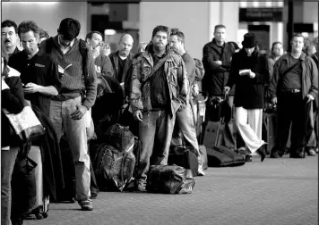  ?? MICHAEL MACOR / SAN FRANCISCO CHRONICLE FILE VIA AP (2009) ?? Airline passengers wait in line at San Francisco Internatio­nal Airport after a flight was delayed about two hours due to a storm that rolled through the Bay Area.