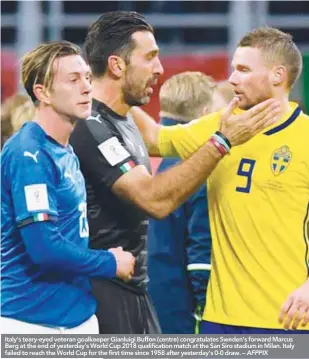  ??  ?? Italy’s teary-eyed veteran goalkeeper Gianluigi Buffon (centre) congratula­tes Sweden’s forward Marcus Berg at the end of yesterday’s World Cup 2018 qualificat­ion match at the San Siro stadium in Milan. Italy failed to reach the World Cup for the first...