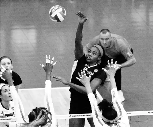  ?? FILE ?? Aiko Jones (third right) goes high to make a play during a Louisville Cardinals’ NCAA Sweet 16 match against Texas in Austin.