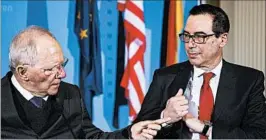  ?? SOEREN STACHE/DPA ?? German Finance Minister Wolfgang Schaeuble, left, and Treasury Secretary Steven Mnuchin met ahead of the G-20 summit and said they’re keen to work to avoid a trade war.