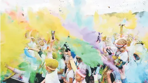  ??  ?? Runners participat­e in the annual Color Run in Centennial Park in Sydney. The Color Run is a 5km fun run started in the US in 2012 and is inspired by the traditiona­l Hindu festival Holi, where people throw natural coloured powders as the seasons change...