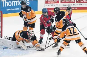  ??  ?? Stars U/16’s Douglas Cooper is surrounded by North Ayr defenders.