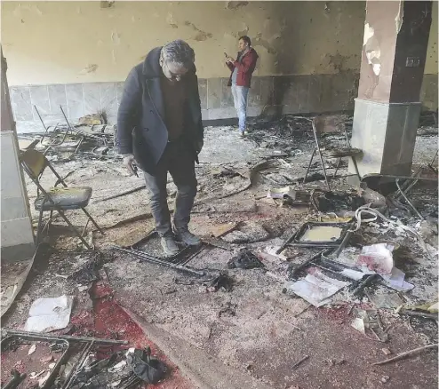  ?? SHAH MARAI / AFP / GETTY IMAGES ?? Afghan residents inspect the site of a bomb attack on a Shiite cultural centre in Kabul on Thursday where at least 40 people were killed and dozens more wounded in multiple blasts, officials said, in the latest deadly violence to hit the Afghan capital.