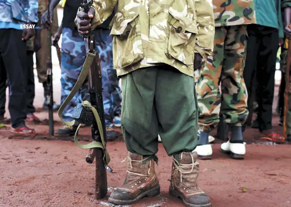  ??  ?? A former child soldier holds a gun as he participat­es in a child soldiers’ release ceremony outside Yambio, South Sudan, in August 2018.