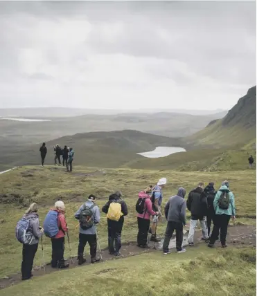  ?? PICTURE; GETTY IMAGES ?? Tourists walk up to visit the Quiraing on the Isle of Skye