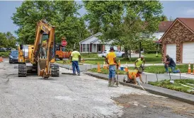  ?? FILE ?? Paving crews repair streets and curbs in Beavercree­k. The city’s 2.15-mill street tax levy will pay for repairs, maintenanc­e and resurfacin­g, according to the city manager.