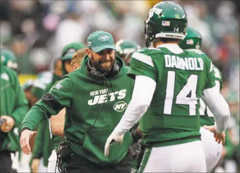  ?? Adam Hunger / Associated Press ?? Jets coach Adam Gase, left, celebrates with quarterbac­k Sam Darnold during the second half of Sunday’s 343 win over the Oakland Raiders.
