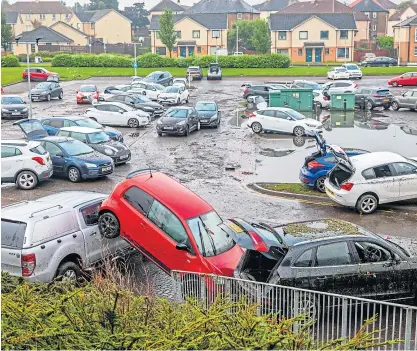  ?? Picture: Steve Brown. ?? Vehicles were badly damaged when the Victoria Hospital car park was flooded.