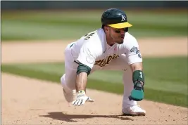  ?? JEFF CHIU — THE ASSOCIATED PRESS ?? The Oakland Athletics' Ramon Laureano steals third base during the fifth inning Sunday against the Los Angeles Angels in Oakland.
