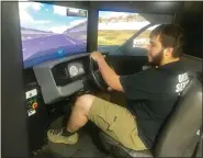  ?? ?? Schuylkill Valley High School student Michael Weber uses the Pennsylvan­ia DUI Safety Simulator at his school May 13.