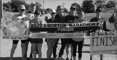  ?? CONTRIBUTE­D ?? Shelley Carroll (centre) at the  nish line during Dr. Gerard MacDonald’s virtual Boston Marathon on Sept. 12. Also in the photo are (from left) Charlene Durham, Anthony Fromm, Amy O’Brien, Ronnie Black, Dr. MacDonald, Victoria Vance and Rajan Minocha-McKenney.