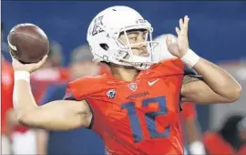  ?? Rick Scuteri
Associated Press ?? QUARTERBAC­K Anu Solomon passes in Arizona’s 77-13 win over Northern Arizona; he has 10 touchdown passes and no intercepti­ons through three games.