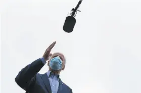  ?? Carolyn Kaster / Associated Press ?? Democratic presidenti­al candidate Joe Biden speaks to reporters in New Castle, Del., before leaving to campaign in the key battlegrou­nd state of Ohio.