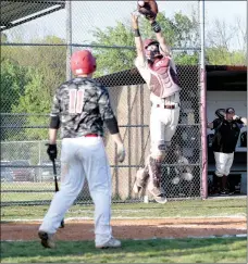  ?? Bud Sullins/Special to Siloam Sunday ?? Freshman catcher Taylor Pool goes high in the air to catch a ball during Wednesday’s game against Russellvil­le.