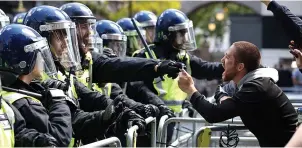  ??  ?? ‘Lack of support’…police are confronted by protesters in Whitehall, London