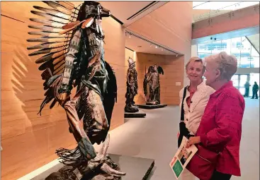  ?? TAMARA LUSH/AP PHOTO ?? Visitors looking at a piece inside the James Museum of Western & Wildlife Art in St. Petersburg, Fla.