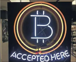  ?? [GILLIAN FLACCUS/THE ASSOCIATED PRESS] ?? Buying with bitcoin can be as easy as tapping your phone, although there are cautions.