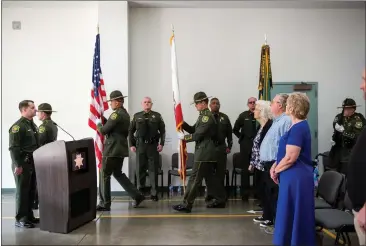  ?? PHOTOS BY MICHAEL WEBER — ENTERPRISE-RECORD ?? Butte County Sheriff’s Office deputies march with flags Friday at the Butte County Sheriff’s Office in Oroville.