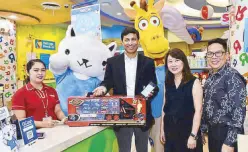  ??  ?? Mynt president and CEO Anthony Thomas together with Toys “R” Us general manager Celina Chua and operations manager Dennis Ramon Navato