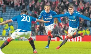  ??  ?? Ianis Hagi enjoys his winning goal with Alfredo Morelos and James Tavernier