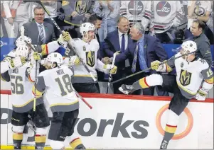  ?? THE CANADIAN PRESS/TREVOR HAGAN ?? The Vegas Golden Knights bench erupts after defeating the Winnipeg Jets in Game 5 of the NHL’s Western Conference Final in Winnipeg on Sunday. Golden Knights assistant coach Mike Kelly of Cornwall, third right, shakes hands with assistant coach Ryan...