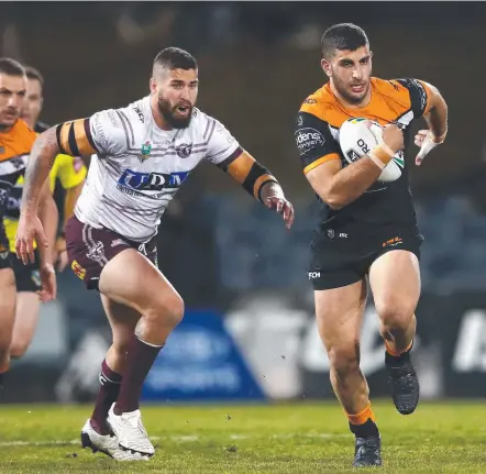  ?? Picture: GETTY IMAGES ?? The Tigers’ Alex Twal makes a break against the Sea Eagles at Campbellto­wn last night.