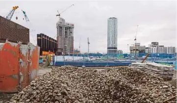  ?? BLOOMBERG PIC ?? Demolition work takes place at the Nine Elms Square constructi­on site in London. Guangzhou R&F Properties and China’s CC Land are acquiring the site for £470 million.
