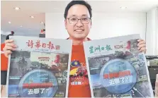  ??  ?? Chong holds up two Chinese newspapers that carry the GST advertisem­ent.