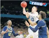  ?? JUNFU HAN/TNS ?? Villanova guard Donte DiVincenzo (10) drives to the basket during the Wildcats’ romp to the title on Monday.