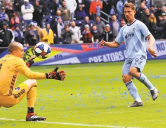  ?? Ryan Weaver / Associated Press ?? Sporting Kansas City forward Krisztian Nemeth chips the ball over Montreal Impact goalkeeper Evan Bush for his third goal of the match Saturday in Kansas City.