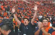  ?? ROSS D. FRANKLIN ASSOCIATED PRESS ?? Suns fan Ryan Maese, middle, cheers along with thousands of others in Phoenix as the Suns pick Deandre Ayton.