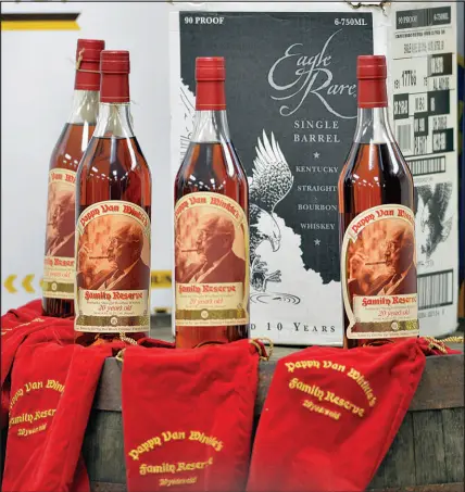  ?? TIMOTHY D. EASLEY / AP FILE (2015) ?? Bottles of 20 year-old Pappy Van Winkle bourbon and Eagle Rare single barrel bourbon are shown in Frankfort, Ky. Over the past decade, bourbon, once known as the drink for the common man, has acquired the cachet of high-end scotches. Bottles that used to sell for under $50 can now fetch several times that amount, especially on the secondary market.