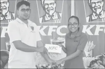  ??  ?? Russell Jubeer (left) receives the sponsorshi­p from KFC’s Senior Accounts Clerk Oma Singh