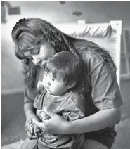  ??  ?? A mother and child at Little Feet Day Care in Farmington, 1999.