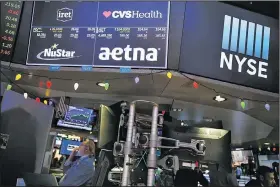  ?? Bloomberg News/MICHAEL NAGLE ?? A monitor displays CVS Health Corp. and Aetna Inc. signs Monday on the floor of the New York Stock Exchange.