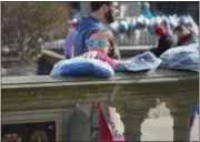  ?? ERIC BONZAR —THE MORNING JOURNAL ?? Eleven-year-old Lizzy Summers, of Elyria, places packaged garments on the ledge of the Elyria Veterans’ Memorial in Ely Square, 100 Middle Ave. in Elyria, on Feb. 20.